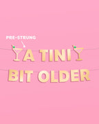 Tini Bit Older Banner - gold foil banner
